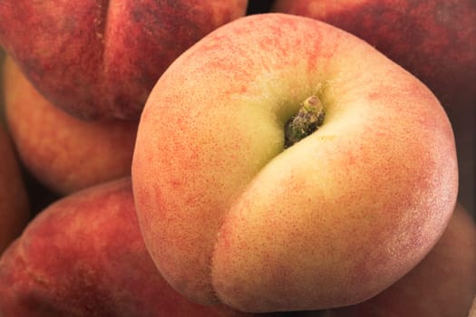 Close Up of flat peach on top of pile.