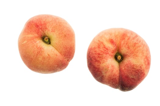 Two flat peaches isolated on white
