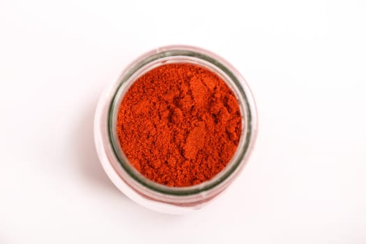 Paprika powder in a glass pot.