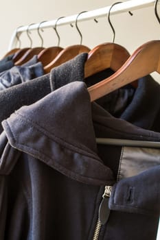 Winter clothes hanged on a clothes rack.
