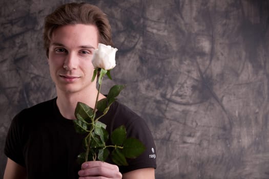 boyfriend giving a white rose to his girlfriend
