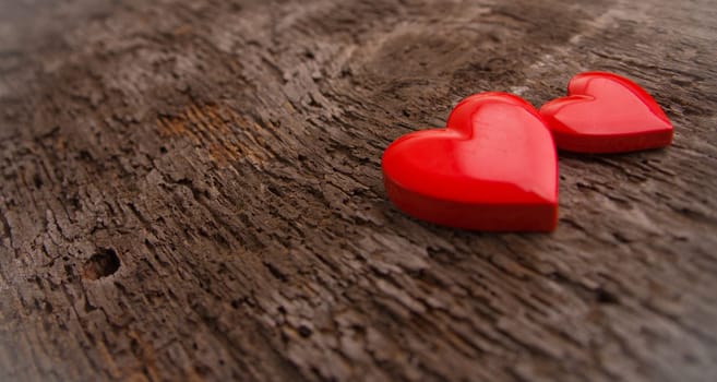 a couple of RED hearts on a scar surface