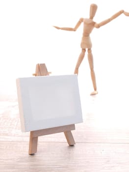 Wooden easel with a blank canvas