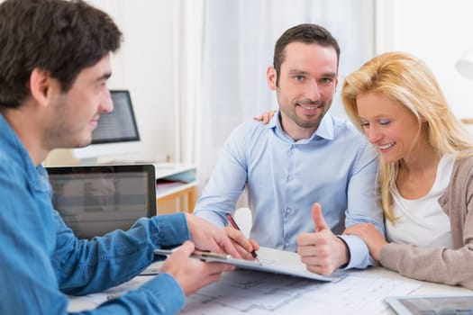 View of a Young attractive couple signing contract