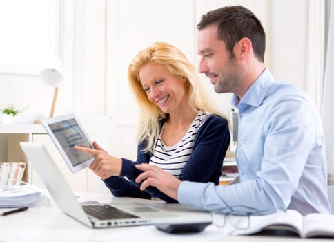 View of a Young attractive couple using tablet at home