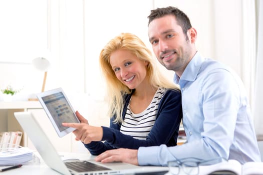 View of a Young attractive couple using tablet at home