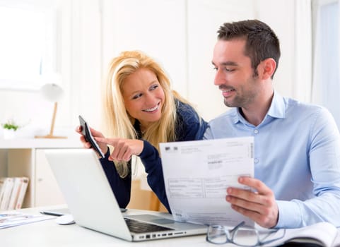VIew of a Young attractive couple doing administrative paperwork