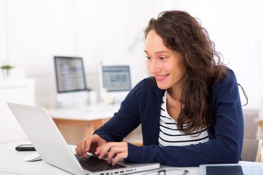 View of a Young attractive student woman working at home
