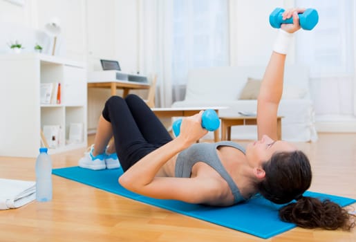 view of a Young attractive girl doing exercise at home