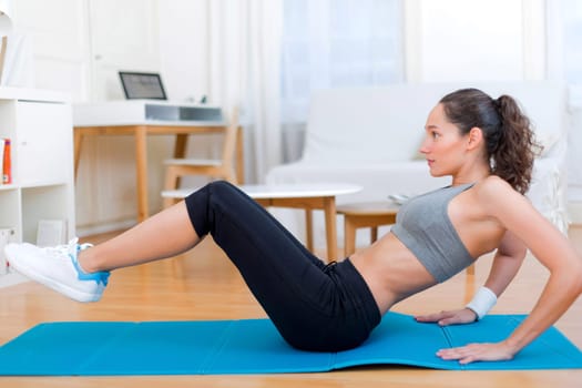 View of a Young attractive girl doing exercise at home