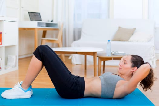 View of a Young attractive girl doing exercise at home
