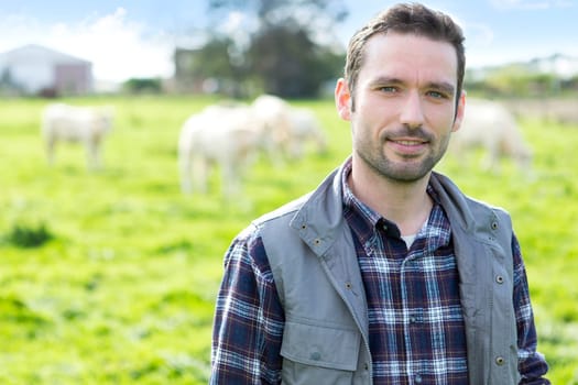 View of a Young attractive farmer working in a field