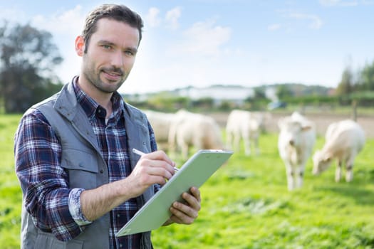 View of a Young attractive farmer working in a field