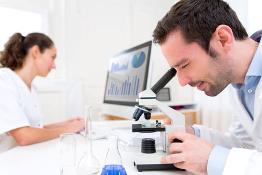 View of a Scientist and her assistant in a laboratory
