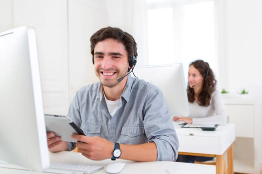 View of a Young attractive man working in a call center