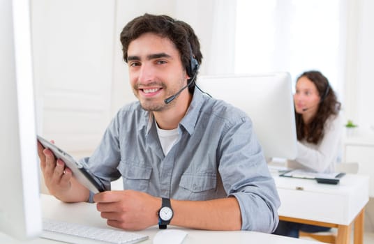 View of a Young attractive man working in a call center