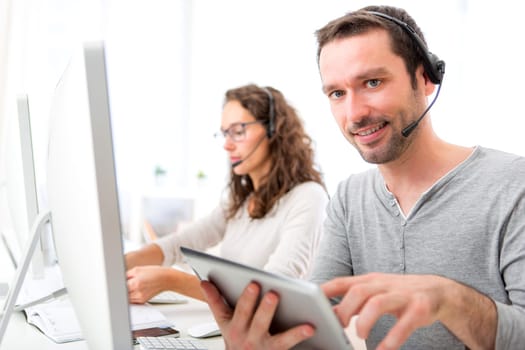 View of a Young attractive man working in a call center