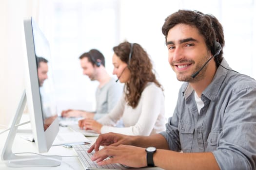 View of a Young attractive man working in a call center