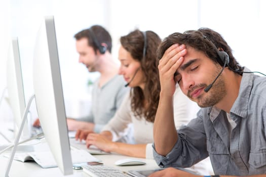 View of a Young attractive man ill-at-ease at work