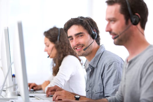 View of a Young attractive man working in a call center