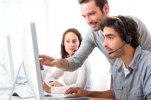 View of a Group of people working around a computer