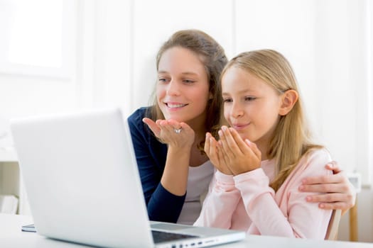 View of an Attractive woman and little sister videocalling