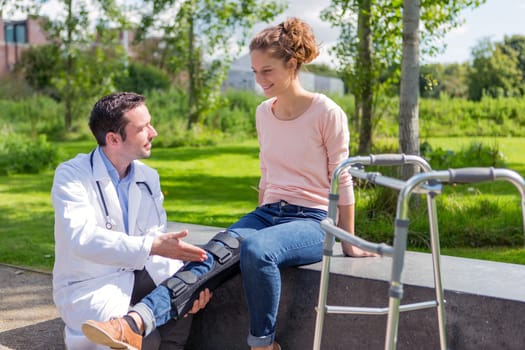 View of a Doctor helping a young woman during reeducation