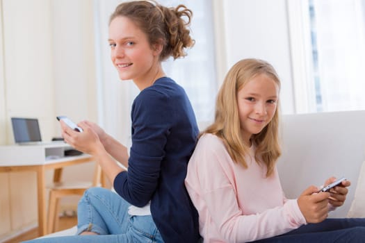 View of an Attractive woman and little sister using mobile