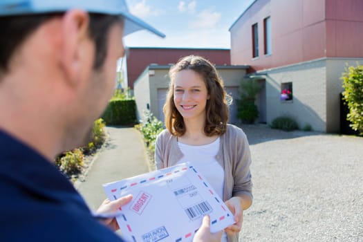 View of a Delivery man handing over a registered mail