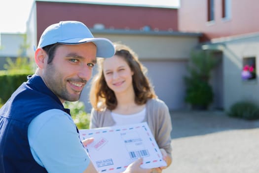 View of a Delivery man handing over a registered mail