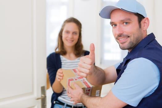 View of a Delivery man handing over a parcel to customer