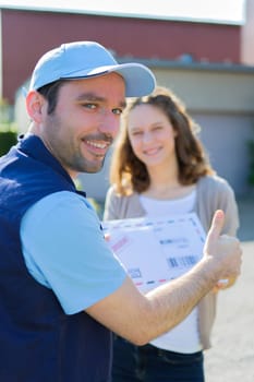 View of a Delivery man handing over a registered mail