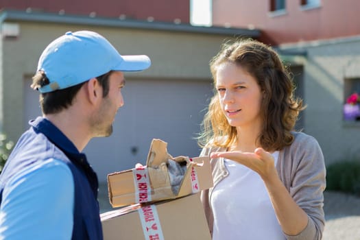 View of a Young attractive woman angry against delivery man
