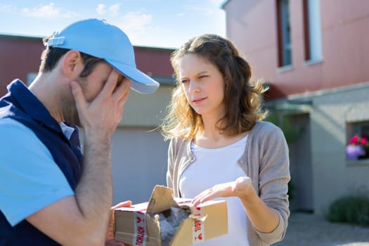 View of a Young attractive woman angry against delivery man