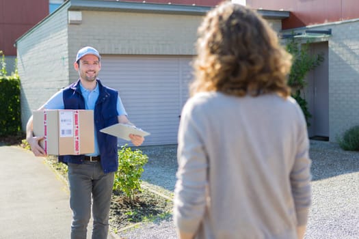View of a Young attractive delivery man on his way to customer