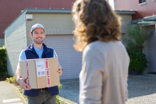 View of a Young attractive delivery man on his way to customer