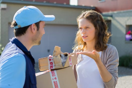 View of a Young attractive woman angry against delivery man