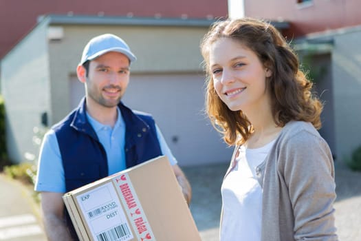 View of a Young attractive delivery man on his way to customer