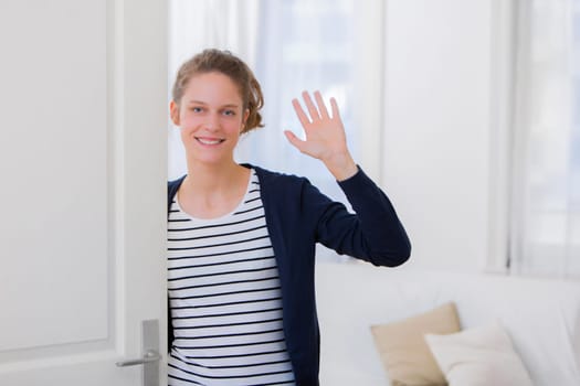 View of a Young attractive woman welcoming you in his house