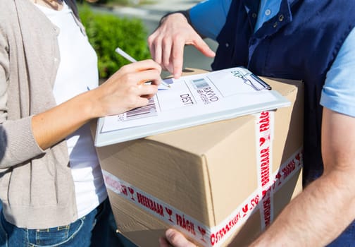 Detailed view of a customer signing delivery note