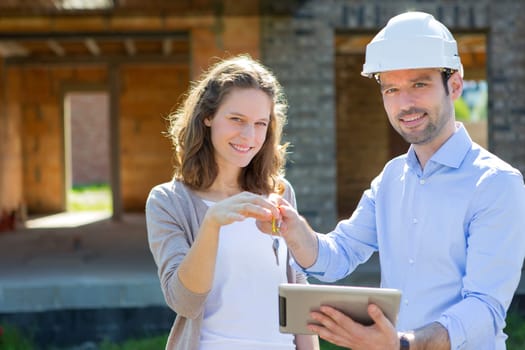 View of a Young woman and architect on construction site