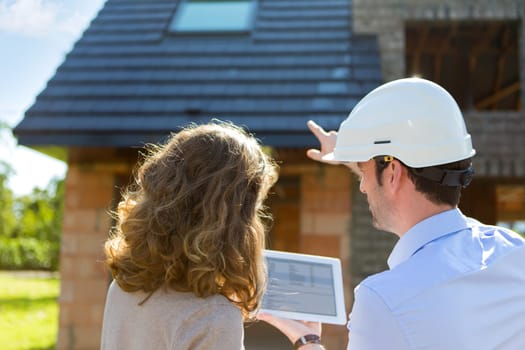 View of a Young woman and architect on construction site
