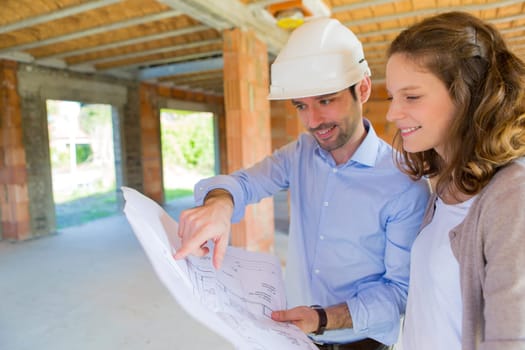 View of a Young woman and architect on construction site