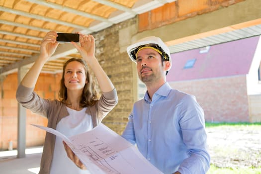 View of a Young woman and architect on construction site