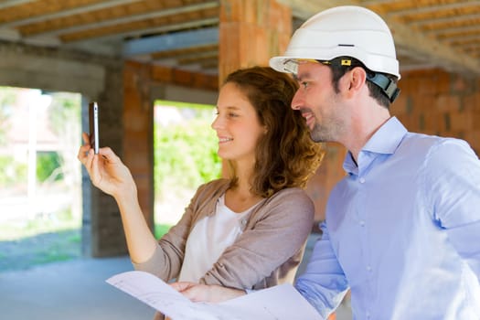View of a Young woman and architect on construction site