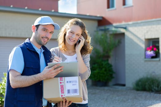 View of a Young attractive woman phoning during a delivery