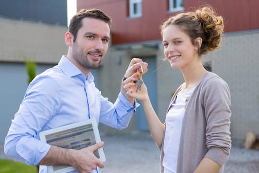 View of a Real estate agent handing over keys