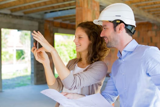 View of a Young woman and architect on construction site