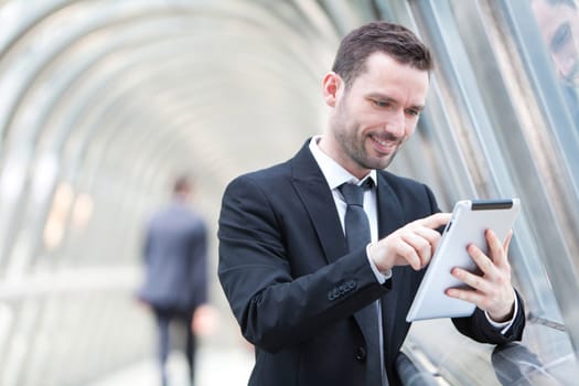 View of an attractive businessman using a tablet