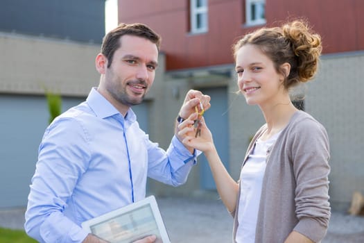 View of a Real estate agent handing over keys